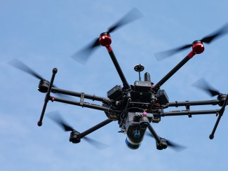 The M600 drone used by Zhou Zhang’s Digital Agriculture Lab flies over an alfalfa field at Arlington Agricultural Research Station