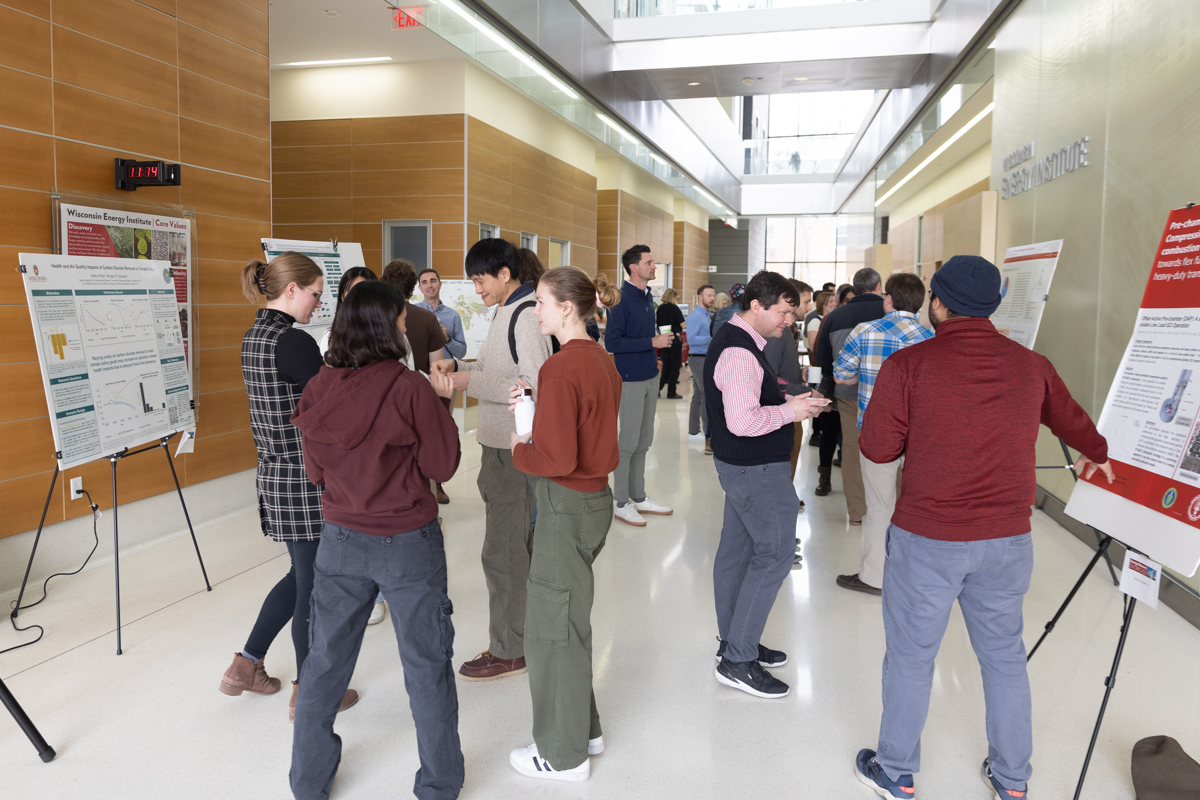 people at a poster session chatting