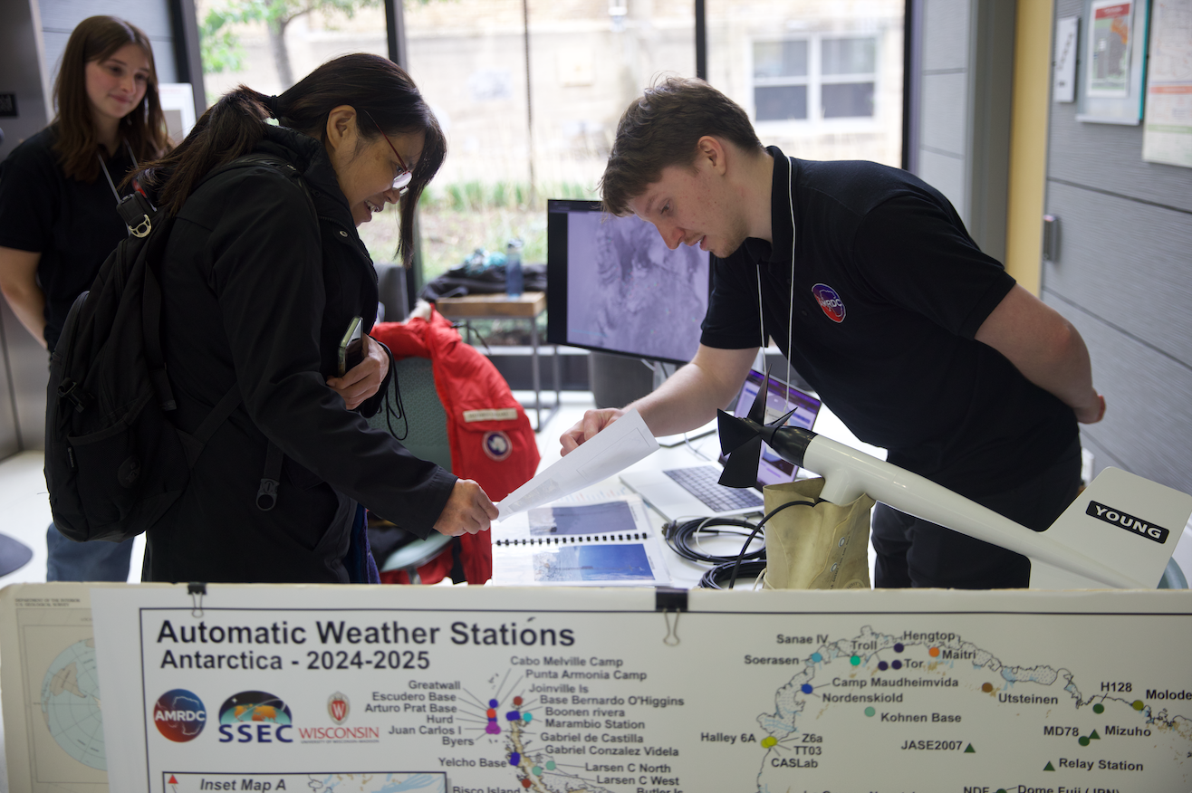 Attendees interact with representatives from Antarctic Meteorological Research and Data Center during the 2nd Annual Wisconsin Weather Fest