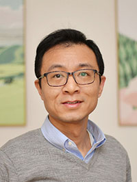 A headshot of Bu Wang