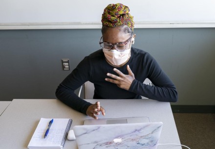 UW-Madison graduate student Kaila Javius-Jones sits in front of a laptop