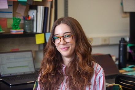 Brunette woman sits at desk