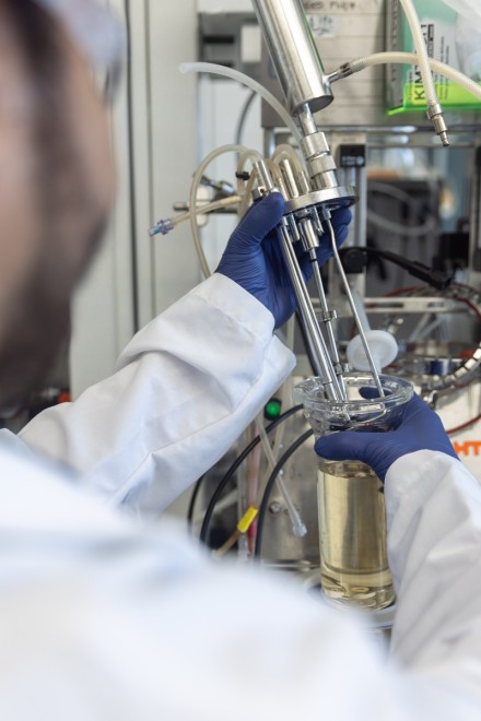 Closeup of hands assembling equipment in a lab