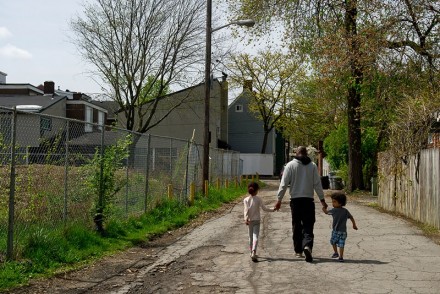 A man walks with his two children in a neighborhood in Pittsburg, Pennsylvania, in May 2016