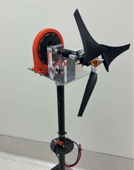 A tabletop wind turbine with three black blades