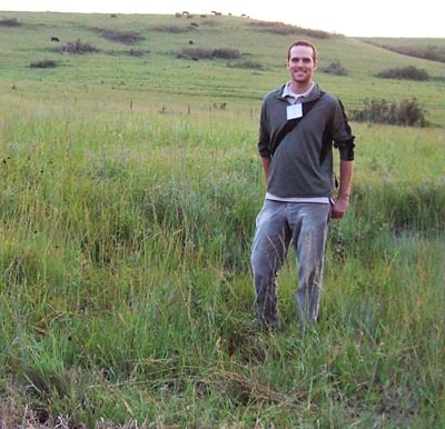Tyler Lark stands in a grassland