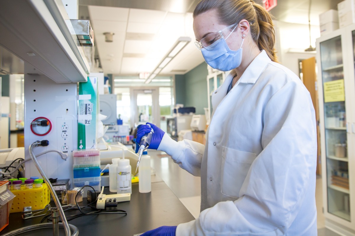 Amy Enright pipettes while working in her lab. 