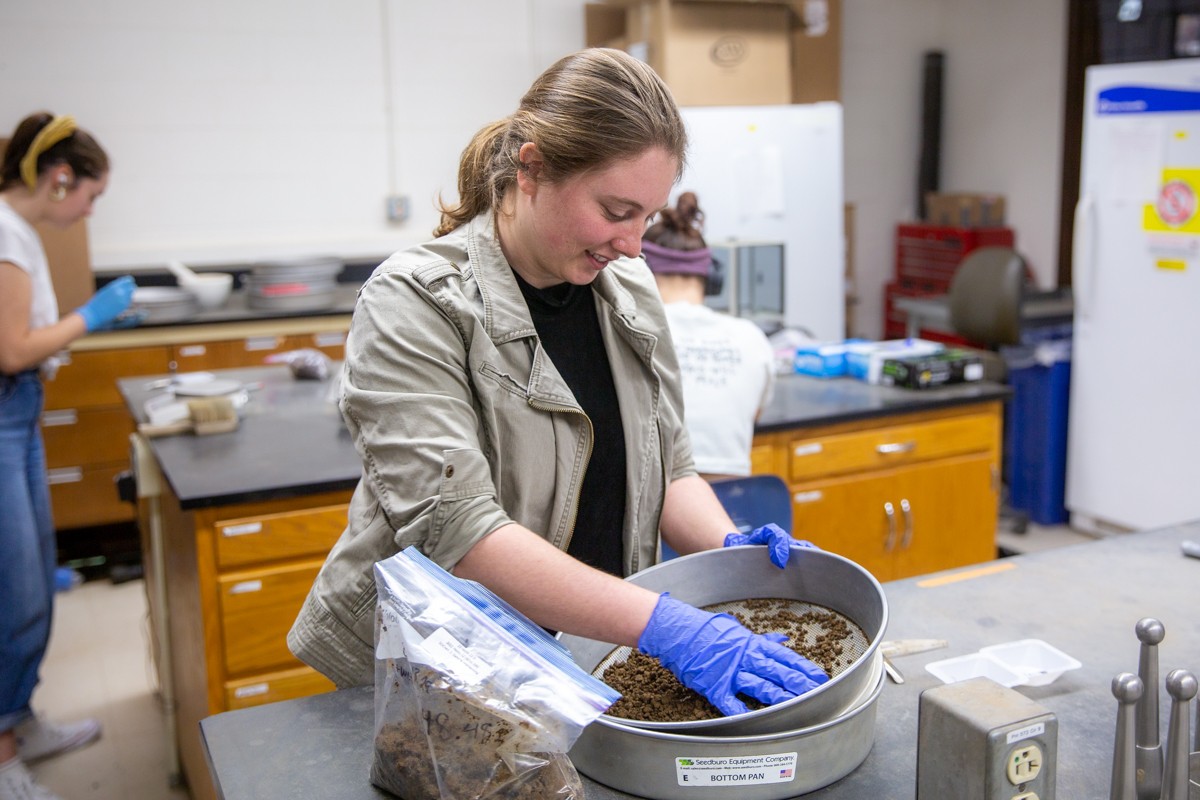 Clare Dietz pushing down soil