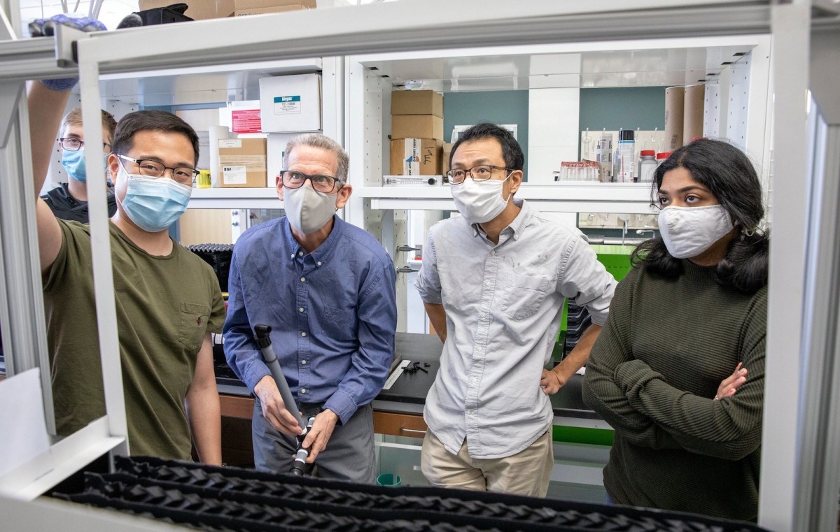 Image of Anex other researchers overlooking Earth RepAIR technology in a lab.