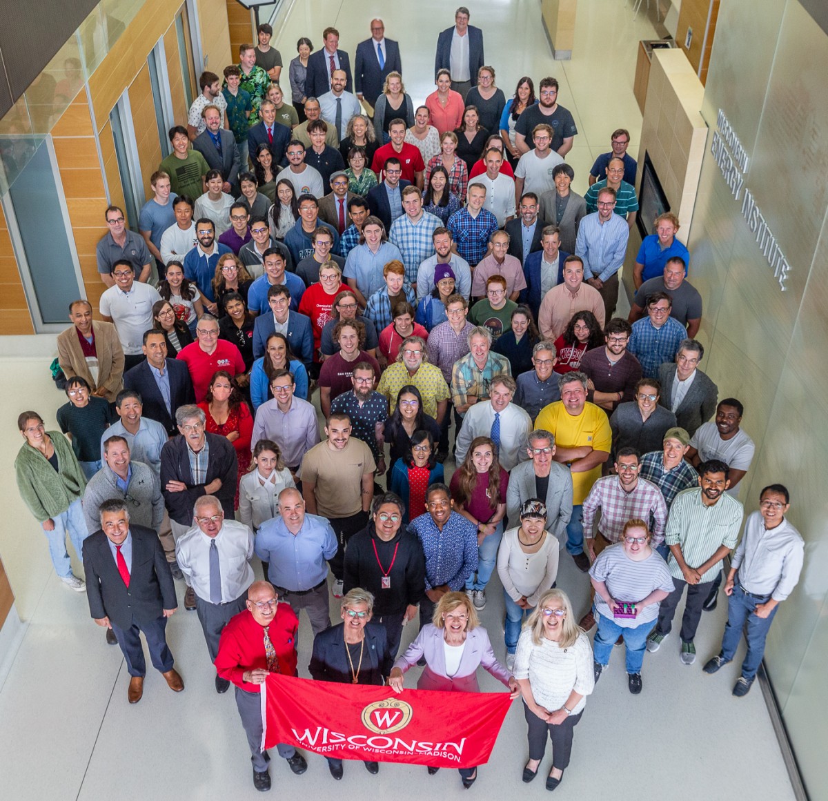 Group of researchers pose with Wisconsin flag