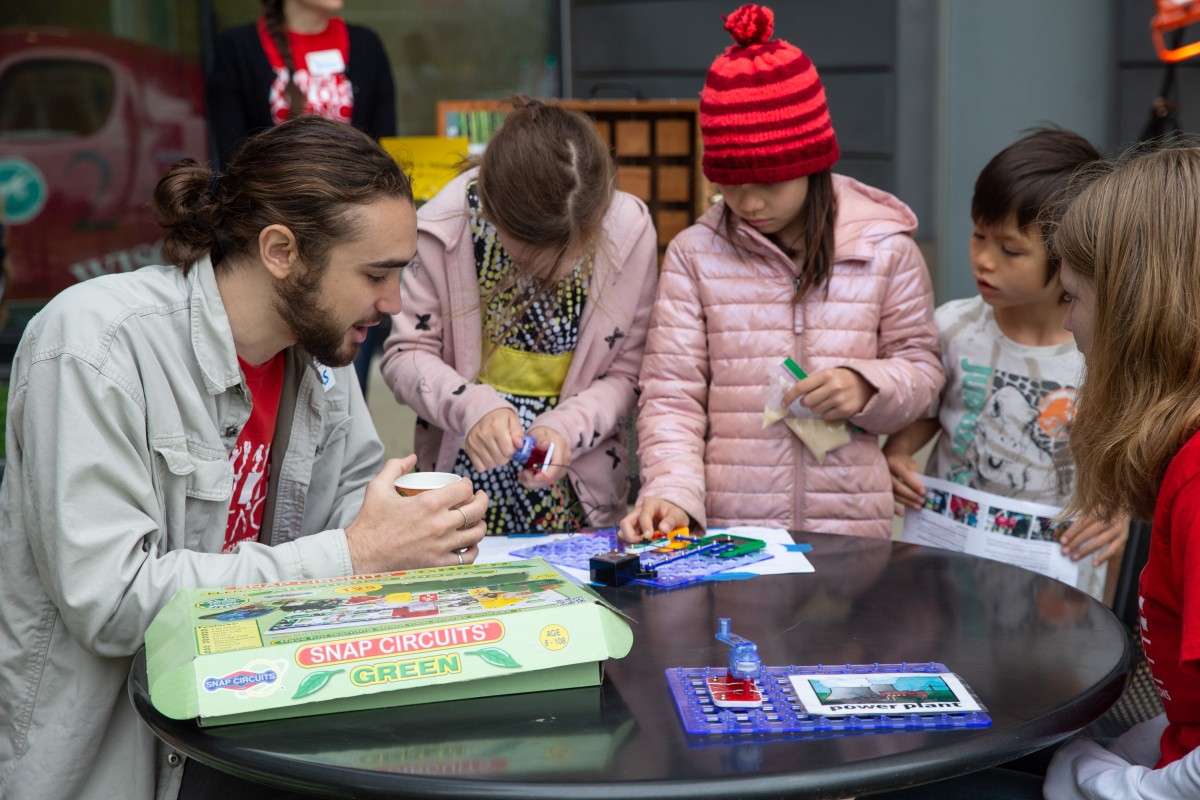 Person shows three kids how to create a mini-microgrid