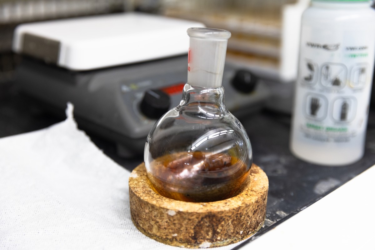 Flask of brown liquid on lab bench