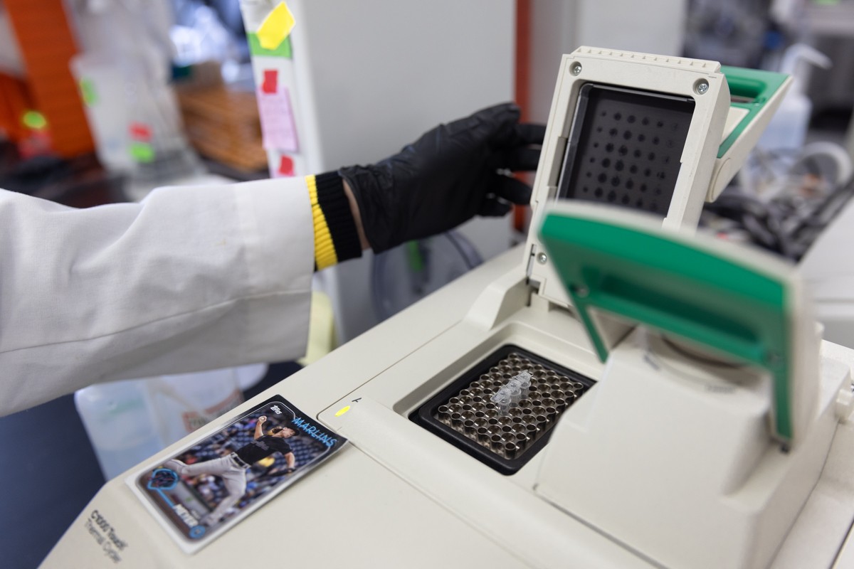 An open PCR machine with a baseball card