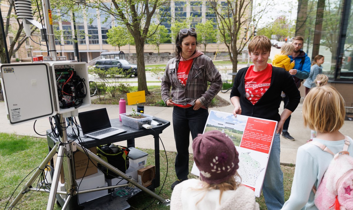 scientists talk to visitors