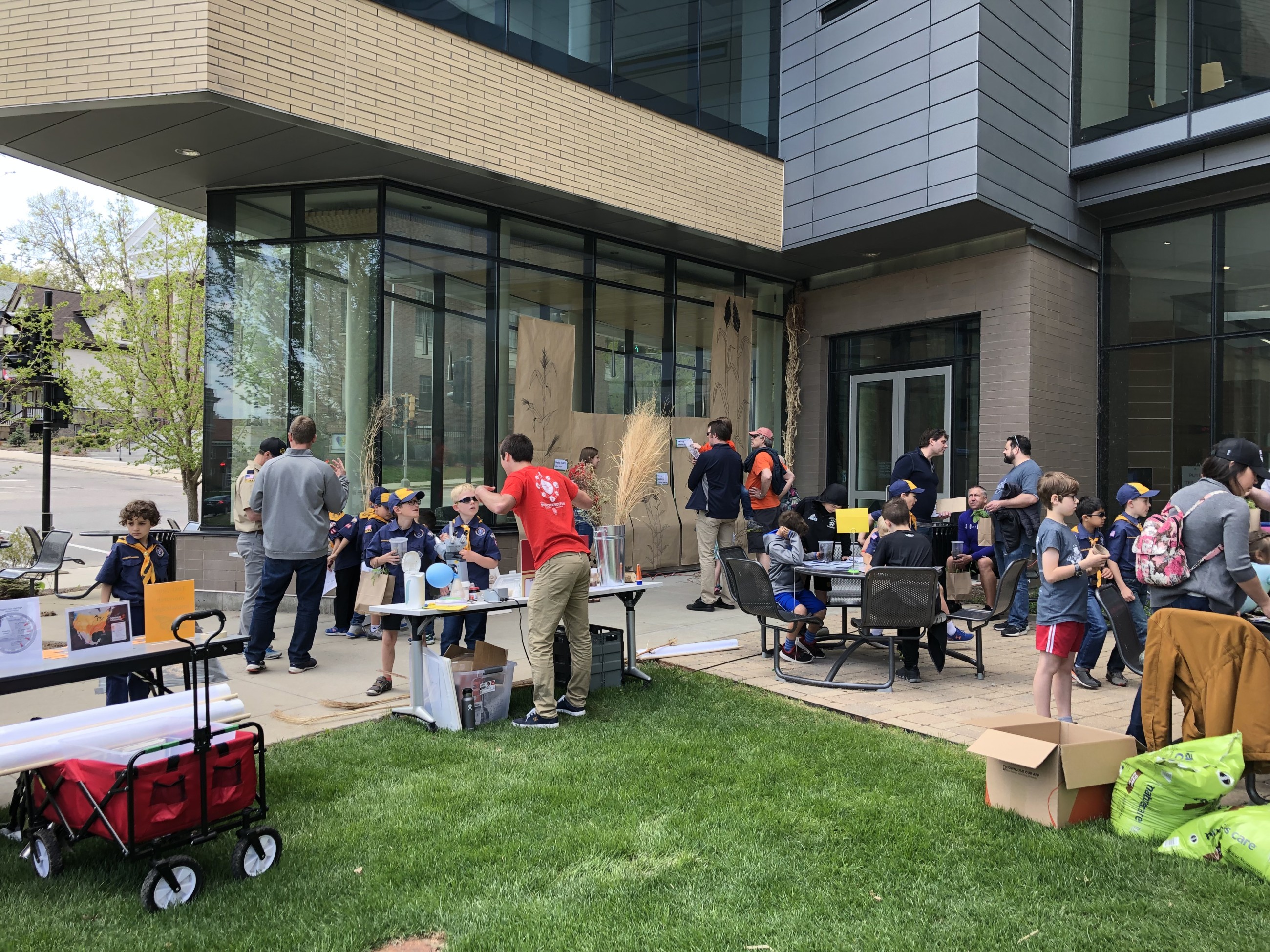 People gather around tables to engage with hands-on science during UW Family Gardening Day.