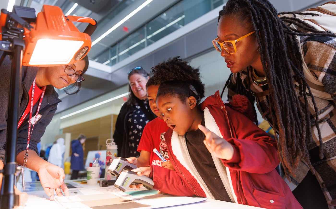 A child and her mom are surprised by the result of a experiment at Science Expeditions.