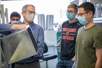 Rob Anex holds a piece of ductwork for a direct air capture unit.