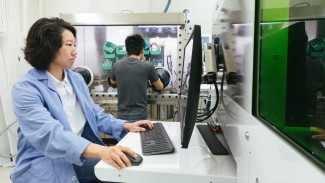 Yafei Wang, a scientist in Couet’s research group and first author on the paper, sits in front of a computer.