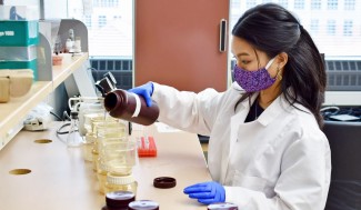 Photo of graduate student Patricia Tran performing an experiment for her research. 