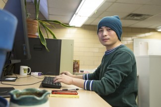 Postdoctoral researcher Xanhua Xie sits in front of a computer at the Wisconsin Energy Institute in Madison, Wis.
