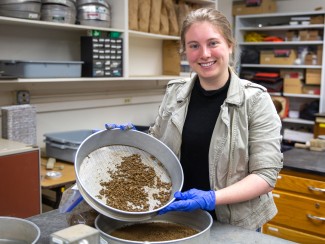 Clare Dietz hold plan with soil.