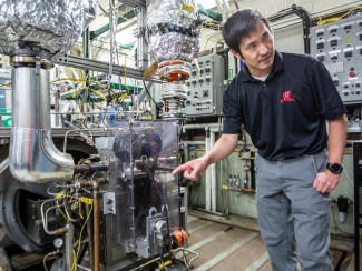 Researcher with engine in lab