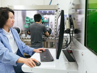 Yafei Wang, a scientist in Couet’s research group and first author on the paper, sits in front of a computer.