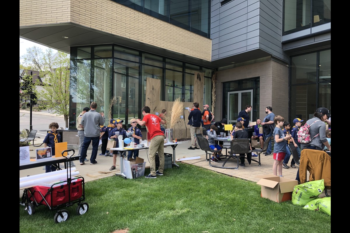 People gather around tables to engage with hands-on science during UW Family Gardening Day.