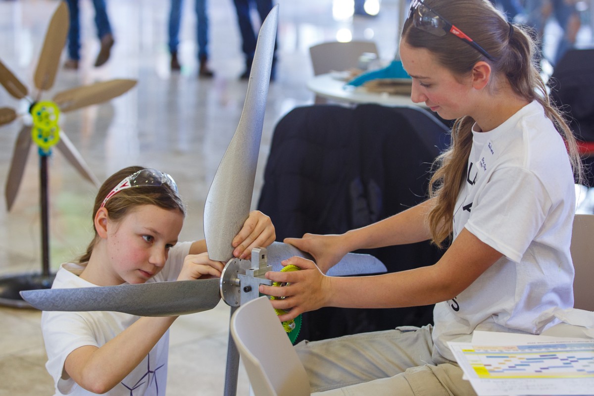 Onalaska High School students Kaarina Dunn (left) and Juliana Dunn make adjustments to their model wind turbine during the 2025 Wisconsin KidWind Challenge
