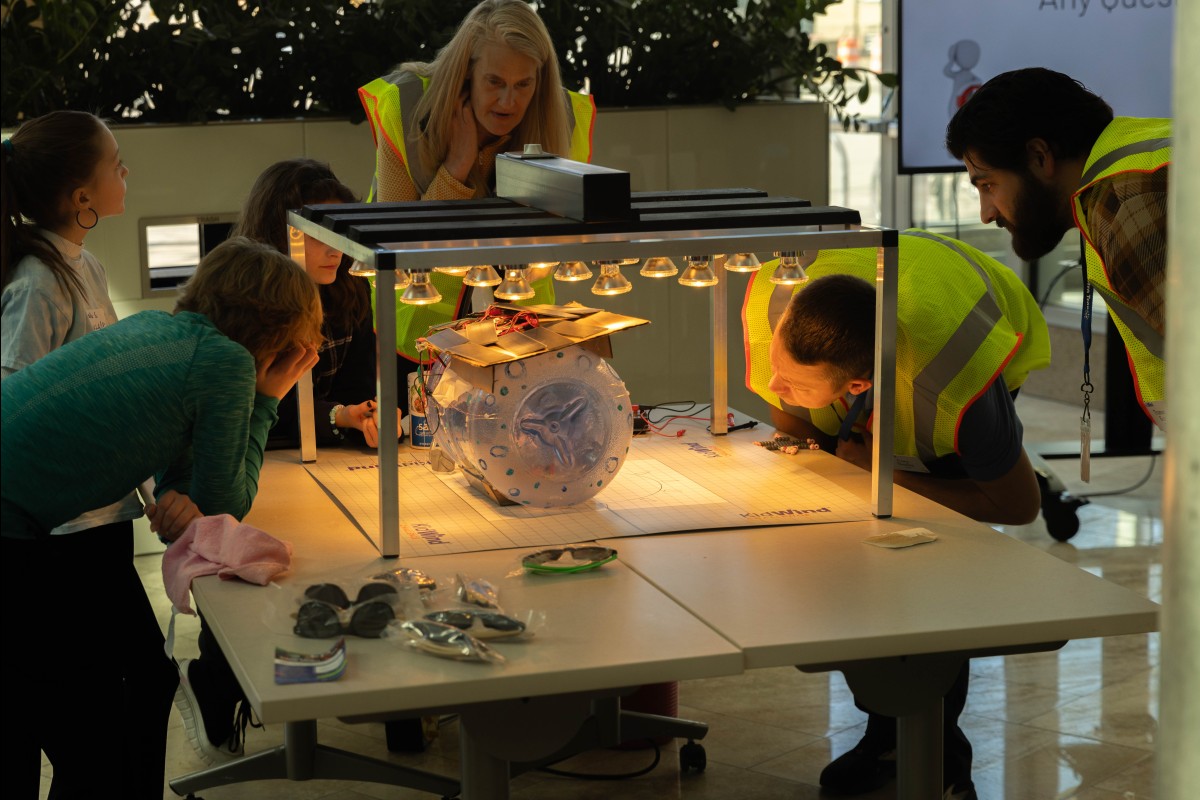 Judges inspect a solar-powered desalination device as part of the Solar Competition.