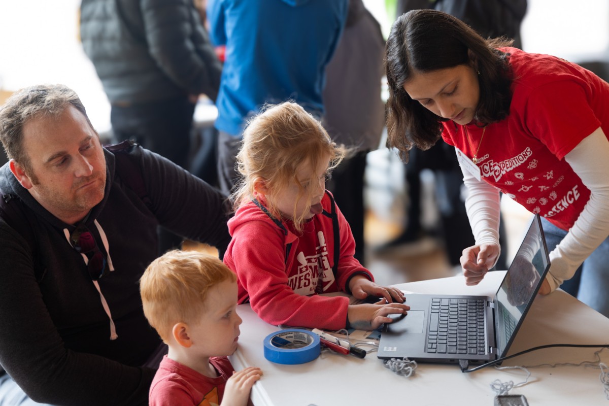 A student prepares to run a wind farm simulation test during science expeditions.