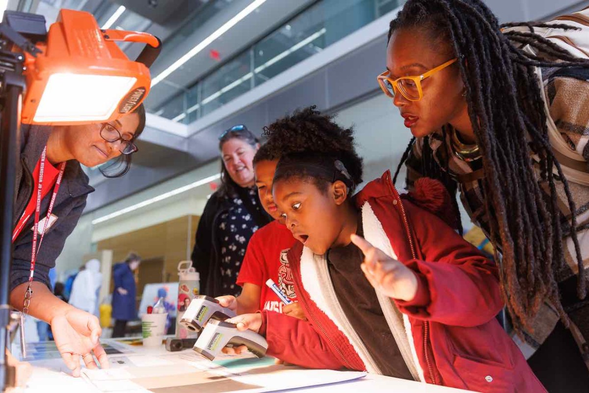 A child and her mom are surprised by the result of a experiment at Science Expeditions.