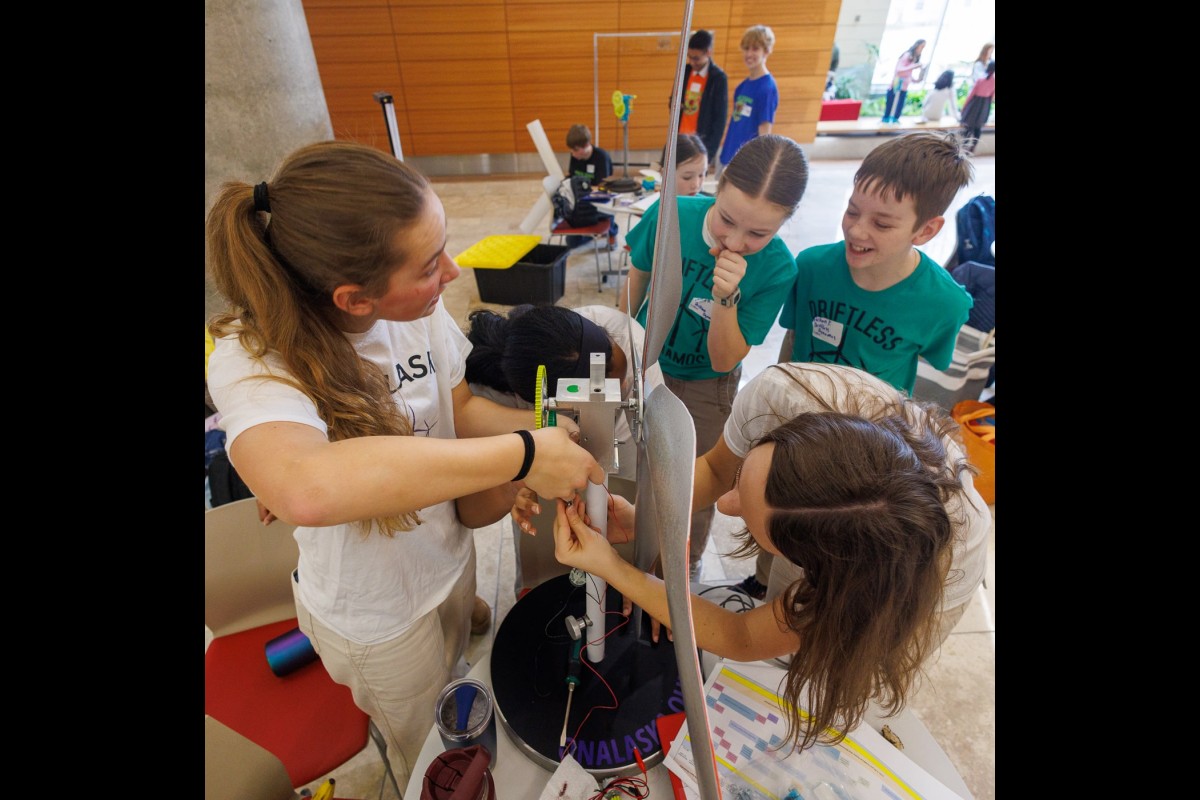 Members of the Onalaska Ohms team make adjustments to their wind turbine. The team placed second in the high school wind category.