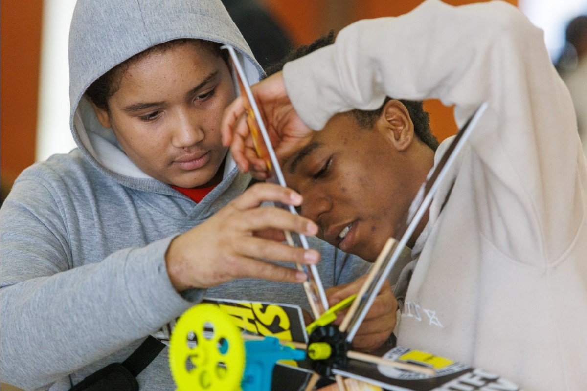 Members of the Hartford Breezy Hawks team make adjustments to their wind turbine. The team placed second in the high school wind category.