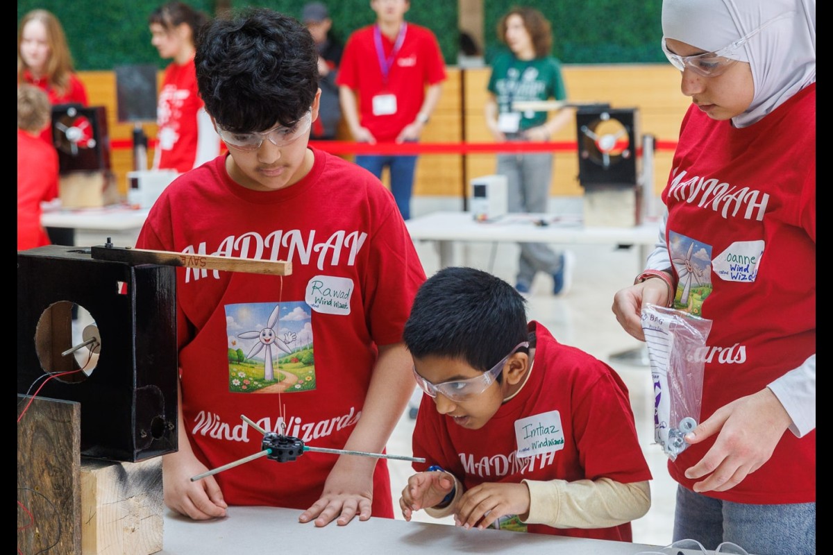 Members of the Madinah Wind Wizards team participate in the blade balancing instant challenge. The team placed second in the elementary school wind category.
