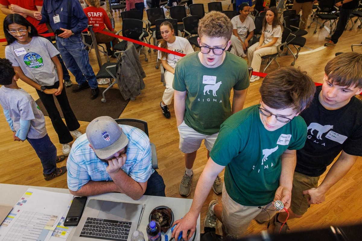 Members of the Mauston Sigma team, right, watch their wind turbine test results appear on a monitor. The team placed first in the high school wind category.